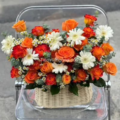 Basket of orange and while tone flowers HG27