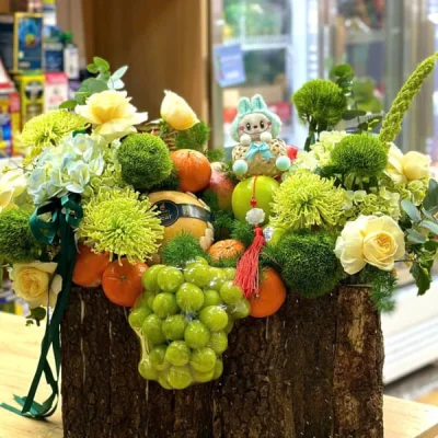Imported fruit basket designed with a mix of fresh flowers in green tone GTC08
